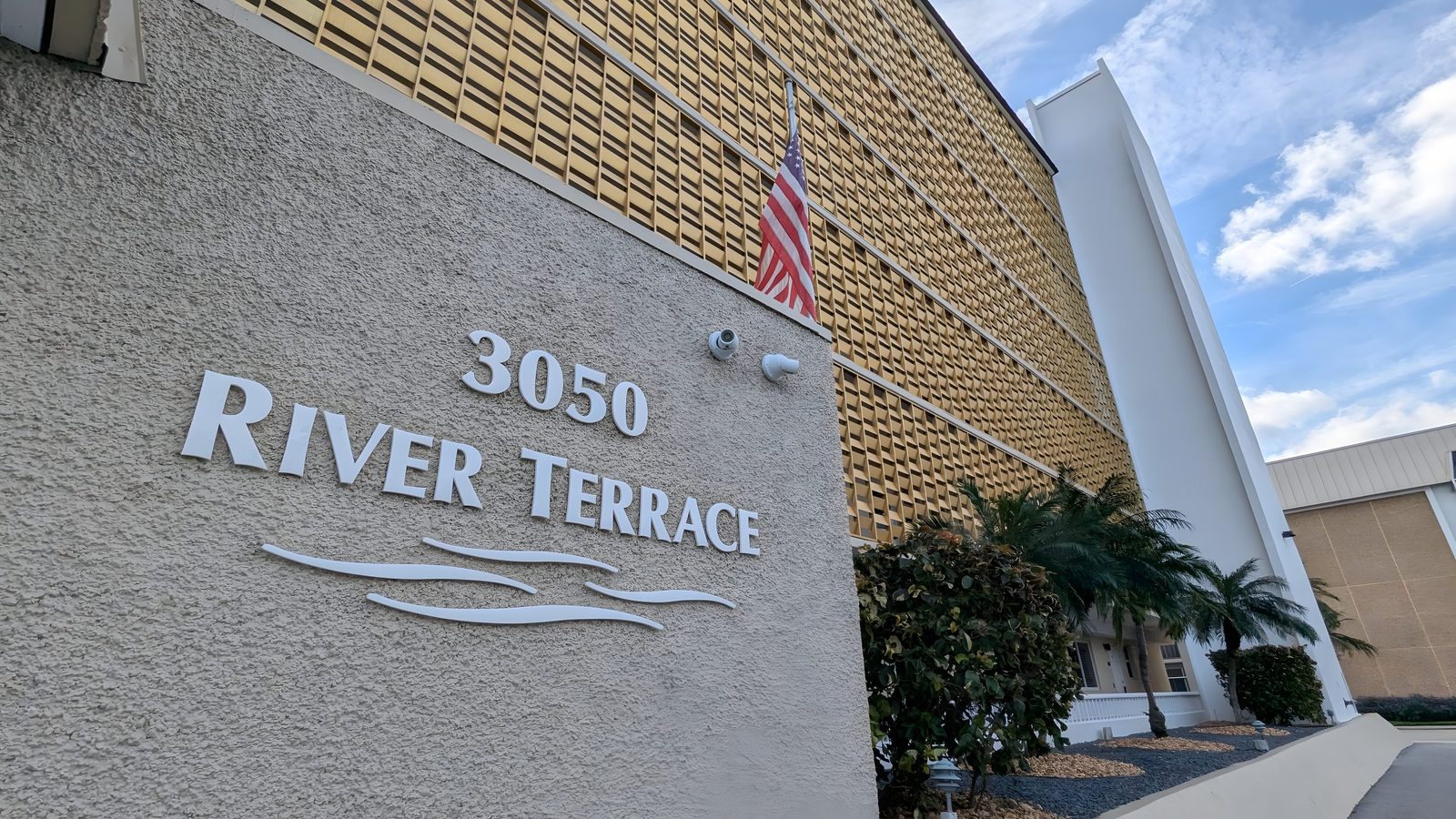 The 3050 River Terrace sign on the facade of the building.