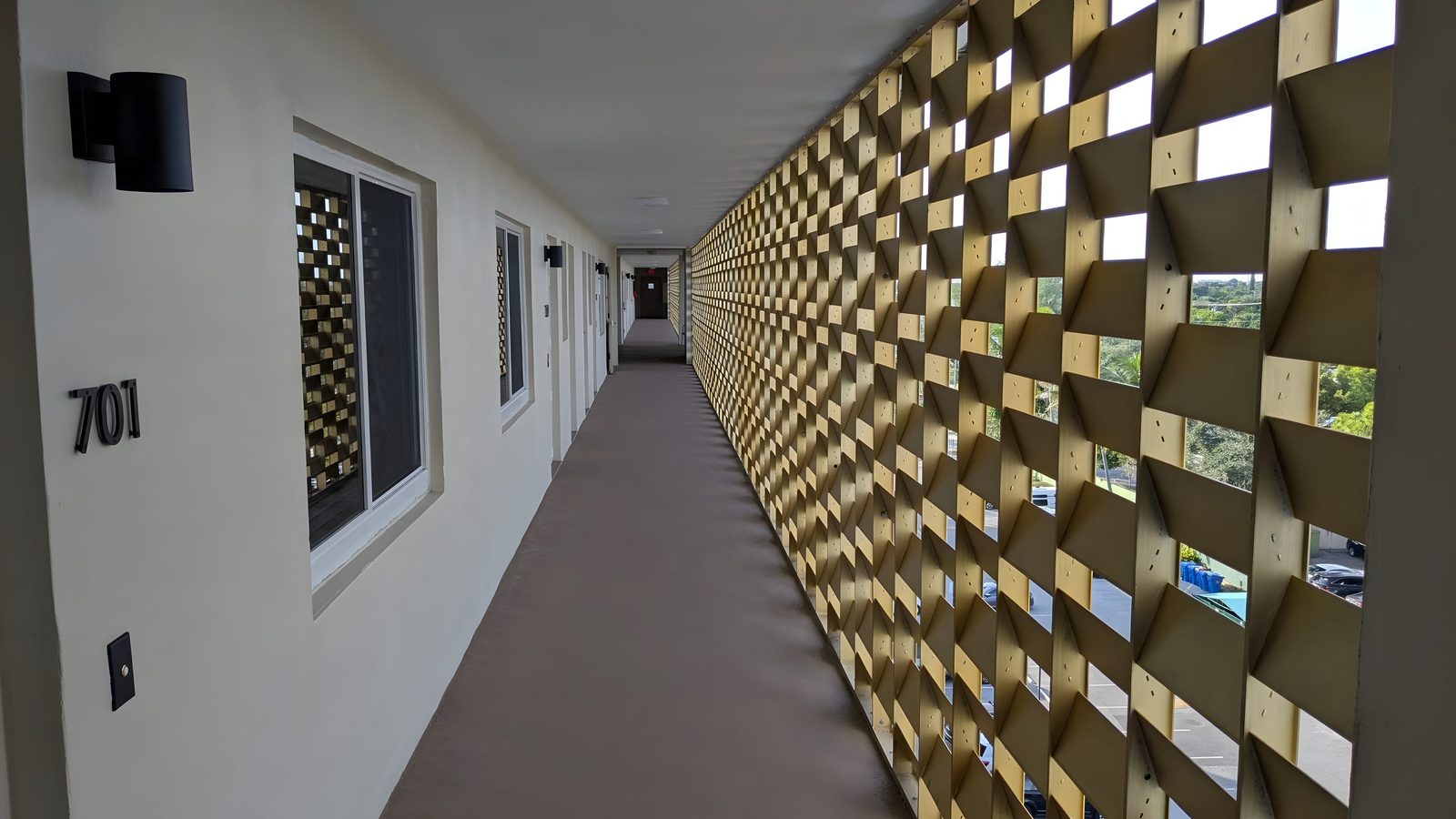 A corridor at River Terrace with the gold screen wall along one side.